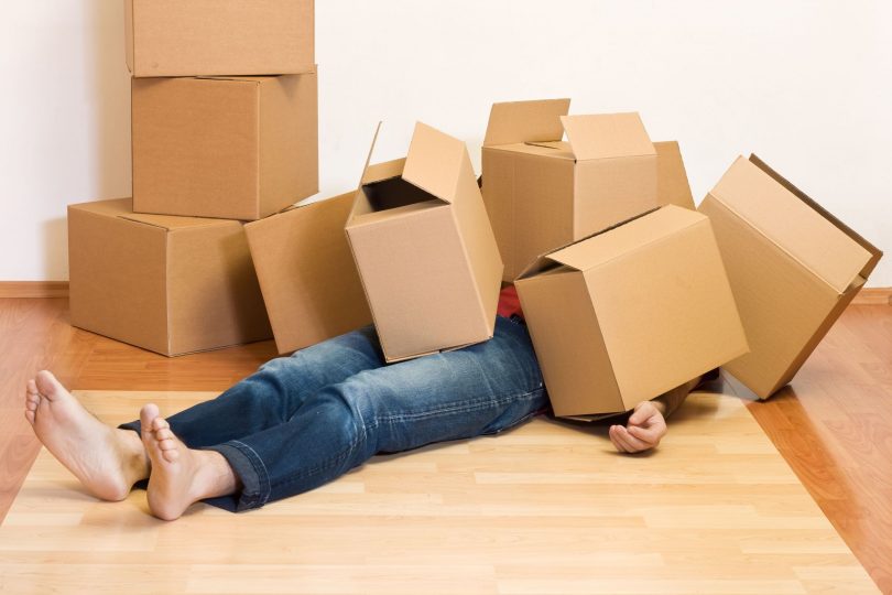 4762000_l-Man-covered-by-lots-of-cardboard-boxes-moving-concept-810x540-1
